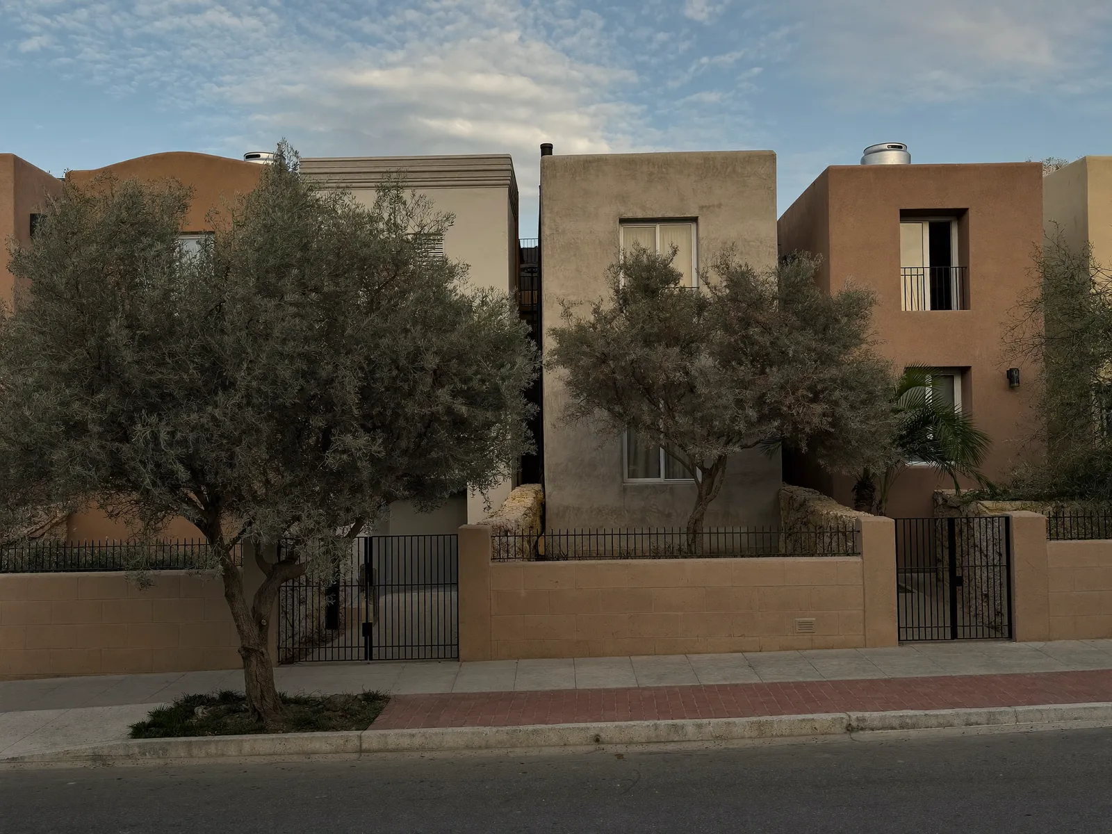 Quiet residential street in Al Safa with older villas behind walls and trees
