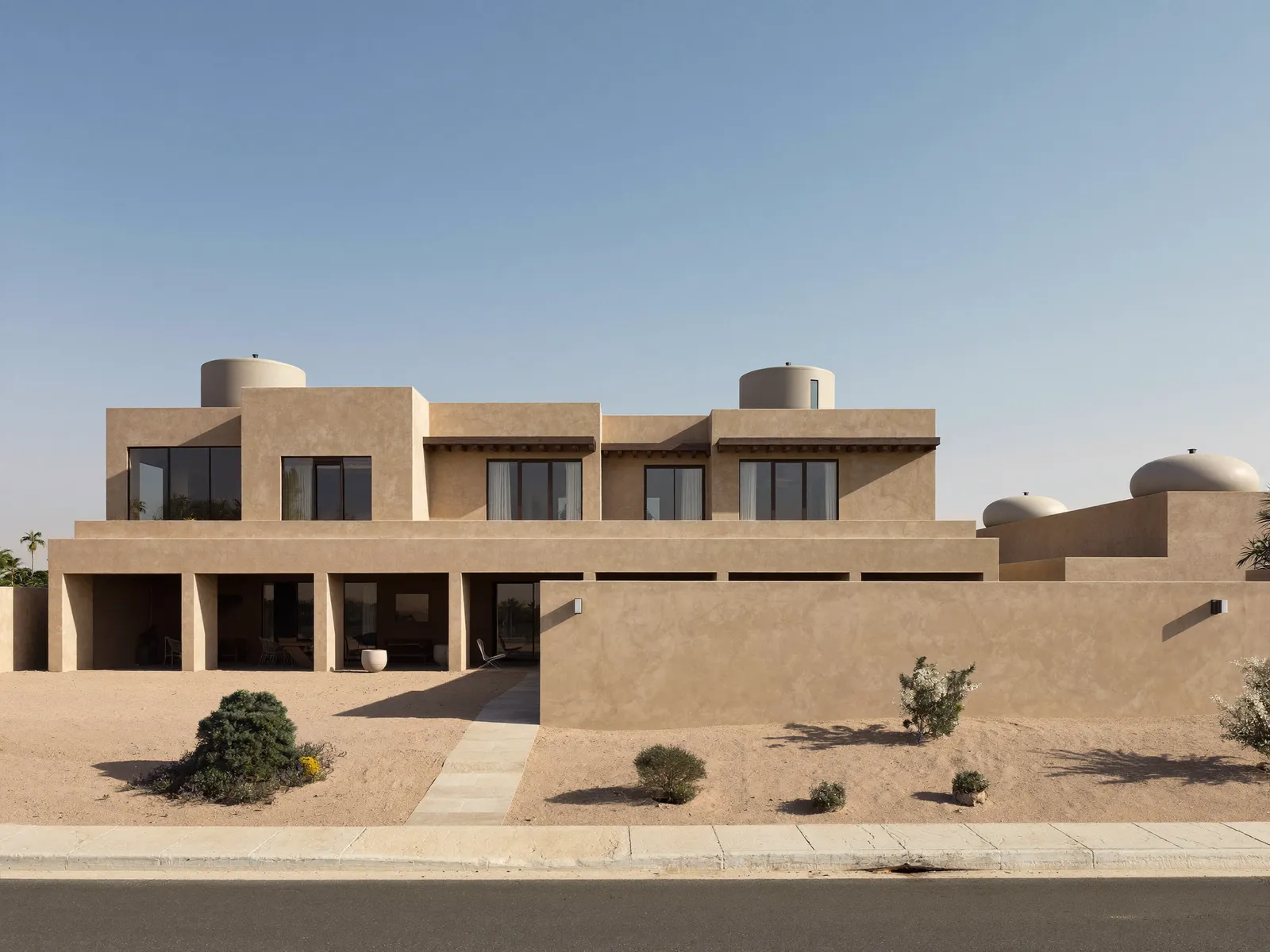 Large family villa in Al Warqa with a high boundary wall and several water tanks on the roof