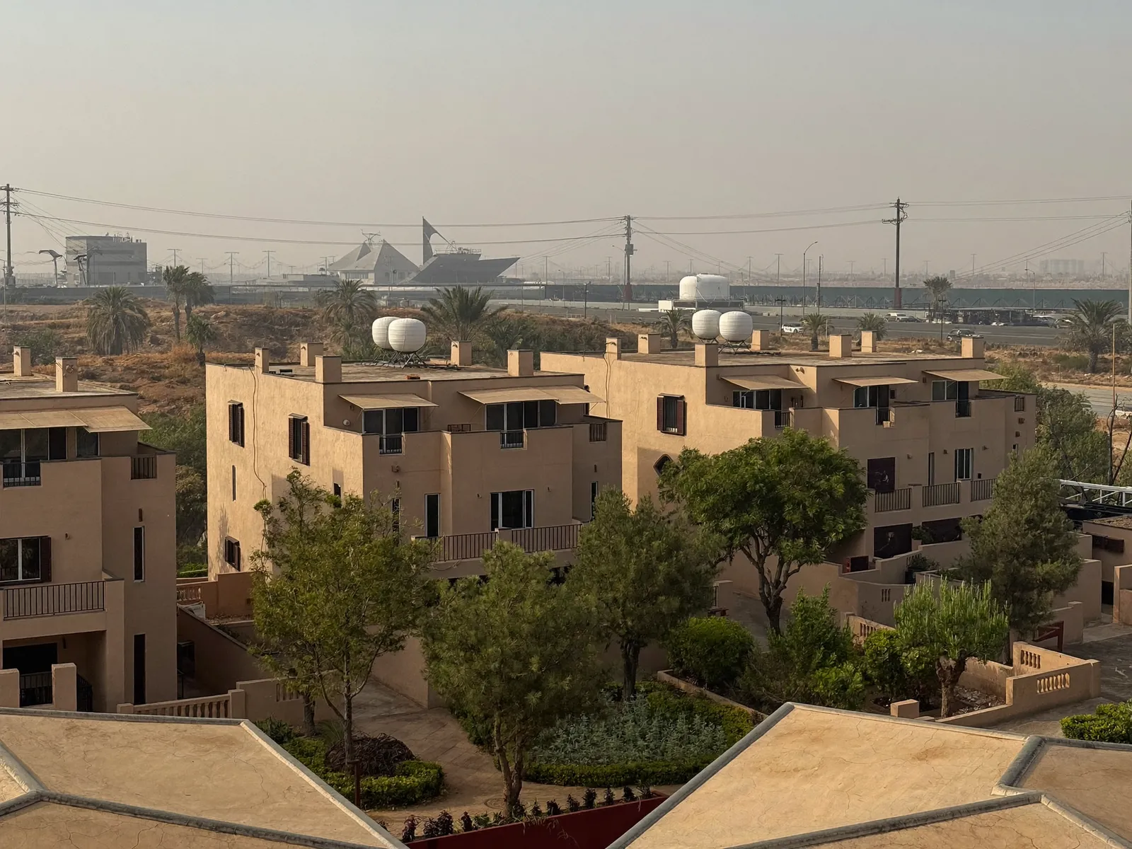 Green Community-style townhouses in Motor City with water tanks on the roofs